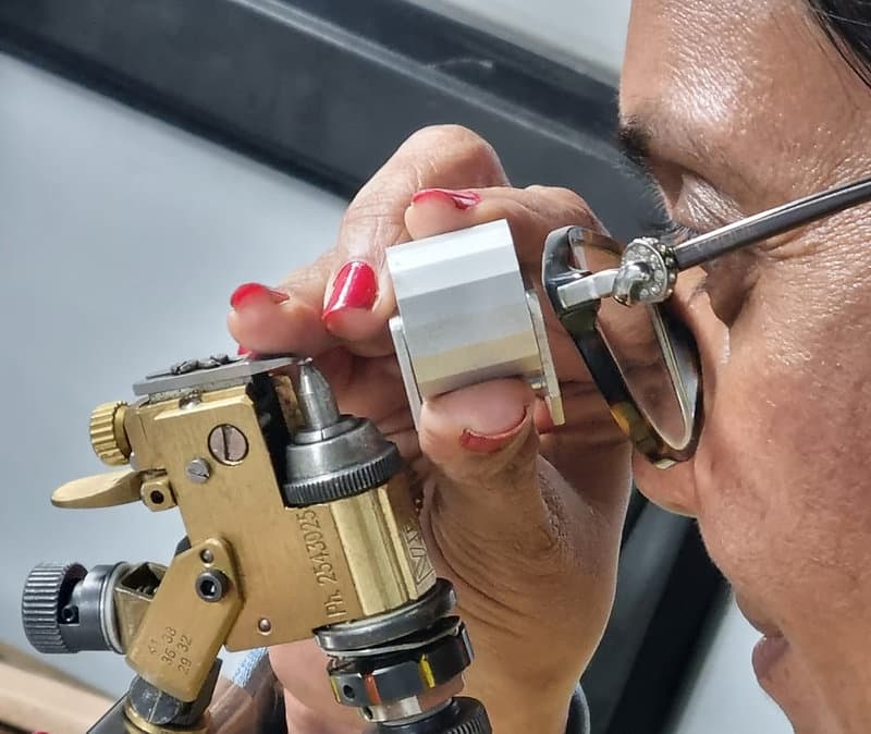 Diamond artisan cutting and polishing a precision-cut stone